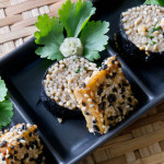 alt="maki rolls stuffed with soba noodles and with small squares of sesame crusted tofu on top. Wasabi served on the side."