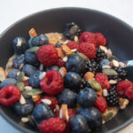 alt="oatmeal topped with fresh berries nuts and seeds."