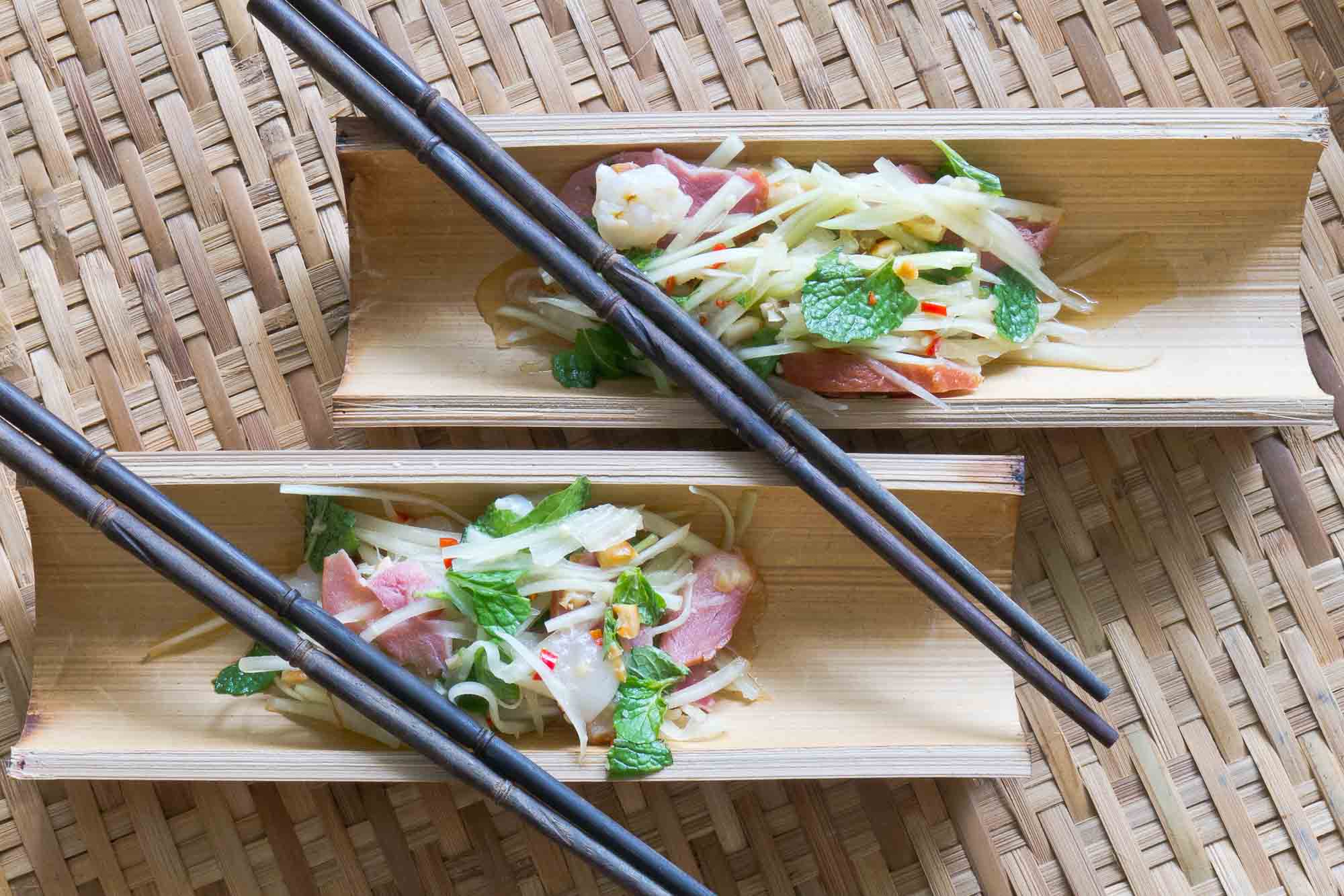 Asian tea-smoked duck salad presented on bamboo trays