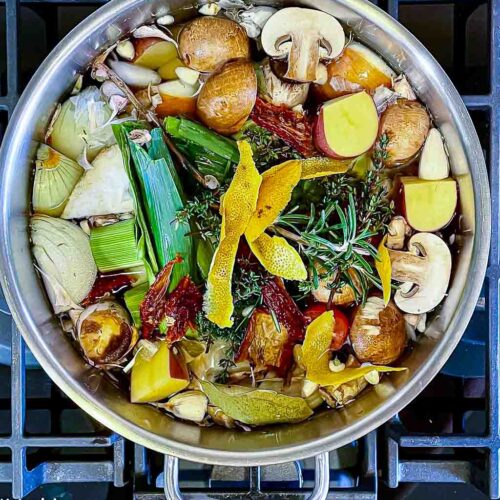 alt="a pot full of the ingredients needed to make homemade vegetable stock ready to go on the stove."