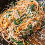alt="Asian rice noodle salad with lots of colorful vegetables."