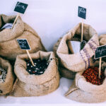alt="five burlap bags with five different types of dried beans."
